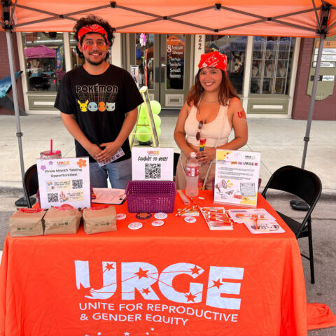 URGE information table with voting handouts.